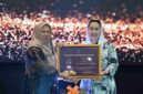 Wakil Gubernur Sulawesi Tengah dr. Reny A. Lamadjido, Sp.PK., M.Kes menyerahkan Paritrana Award kategori pemerintah kabupaten/kota terbaik kepada Wakil Walikota Palu Imelda Liliana Muhidin, S.E., M.A.P.