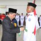 Bupati Pidie Jaya, H. Sibral Malasyi. MA, S.Sos, ME,. Memasang Sabuk pada Perwakilan Pasukan Pengibar Bendera Pusaka (Paskibraka). di Aula Cot Trieng, Kantor Bupati , Rabu (13/8/2025). Foto.Ist.