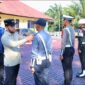Wakil Bupati Aceh Barat Said Fadheil, SH memasang pita kepada perwakilan Personil saat memimpin Apel Gelar Pasukan Operasi Ketupat 2026 di halaman Polres Aceh Barat, Kamis (12/3/2026), Foto Dok: